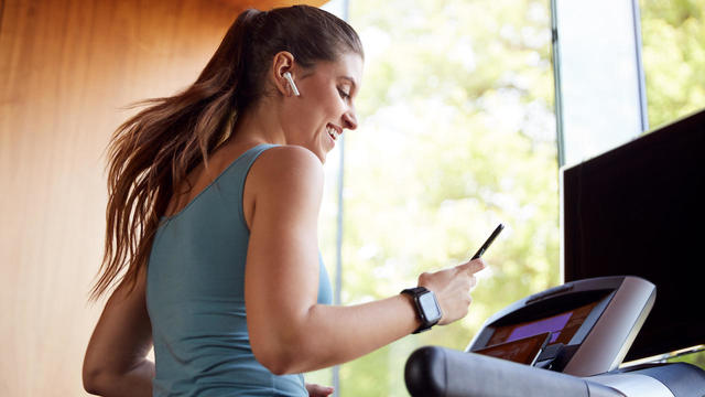 Woman Exercising On Treadmill 