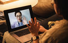 Patient speaks to doctor via video on a laptop 