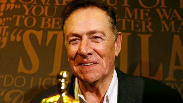 Deer Hunter screenwriter Redeker poses near an Oscar statuette at an event in Hollywood 