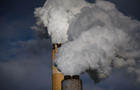 Steam billows out of the stacks at a coal-fired power plant 