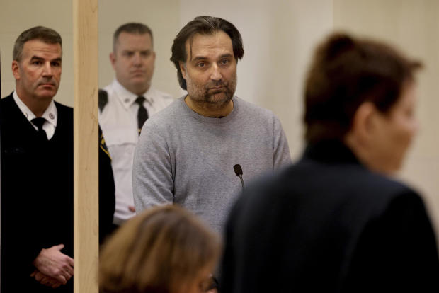 Brian Walshe, center, listens during his arraignment Jan. 18, 2023, at Quincy District Court, in Quincy, Mass., on a charge of murdering his wife Ana Walshe. 