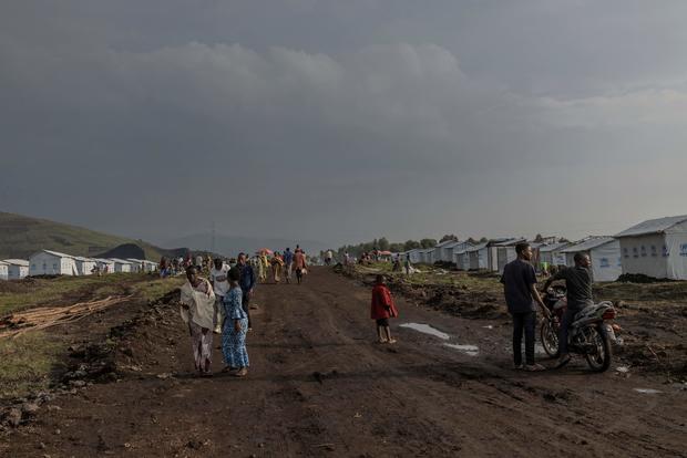 Internally displaced people walk on a road at the Bushagara site, north of the city of Goma in eastern Democratic Republic of Congo, on Jan. 13, 2023