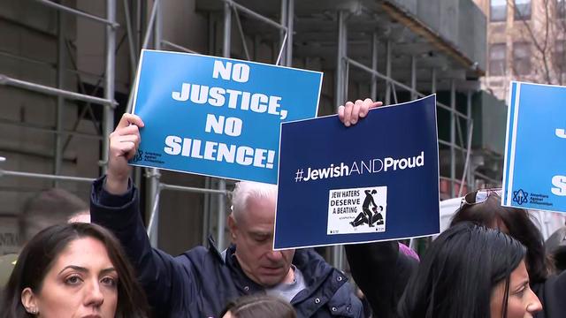 Demonstrators hold blue signs reading "No justice, no silence!" and "#JewishANDProud." 