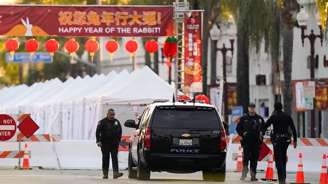 Police officers stand outside a ballroom dance club in Monterey Park, California, on Sunday, Jan. 22, 2023. 