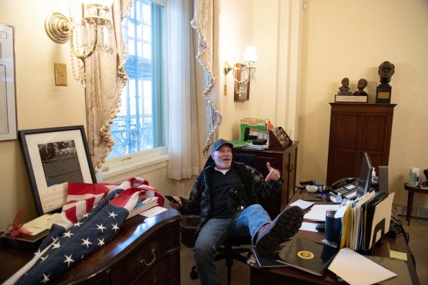 Richard Barnett inside the office of House Speaker Nancy Pelosi during the attack on the U.S. Capitol on Jan. 6, 2021. 