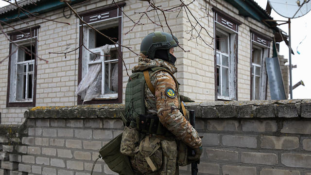 A Ukrainian soldier observes the situation near the northern 