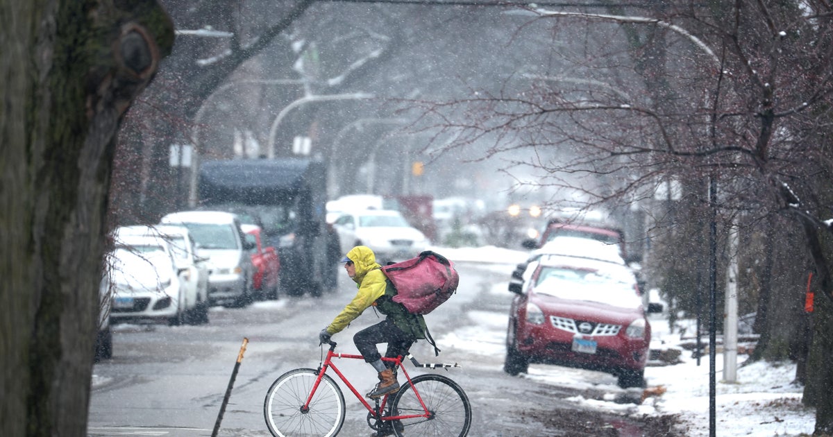 Storm system dumps heavy snow on Indiana and Michigan after bringing tornado damage to Texas