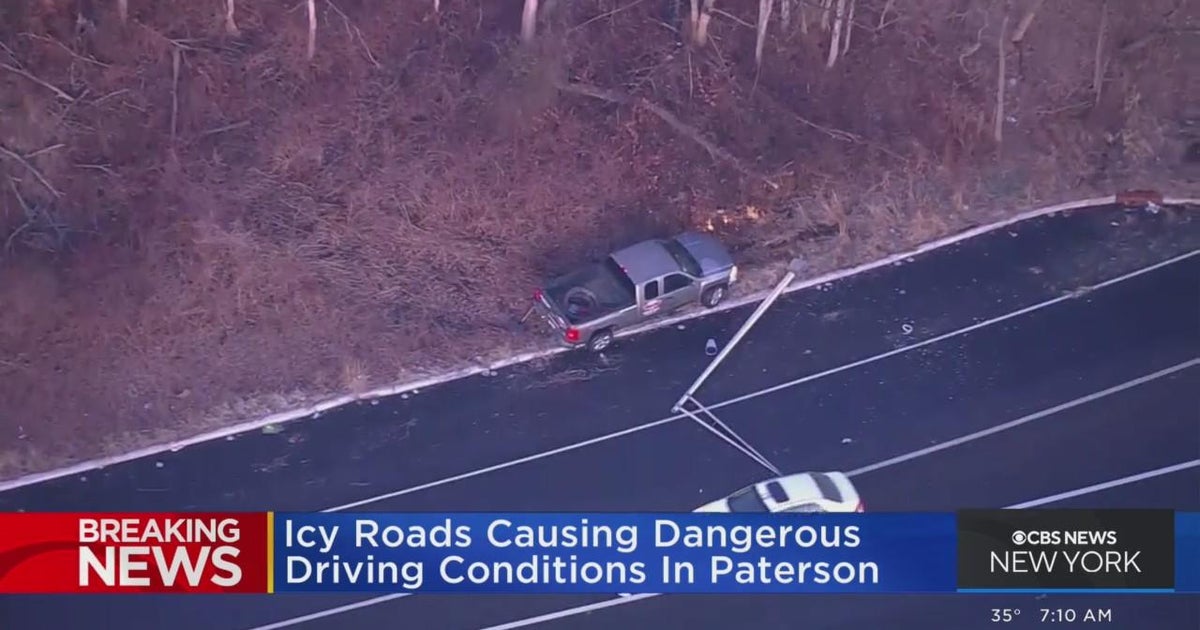 Car spins out, crashes into light pole in icy conditions - CBS New York
