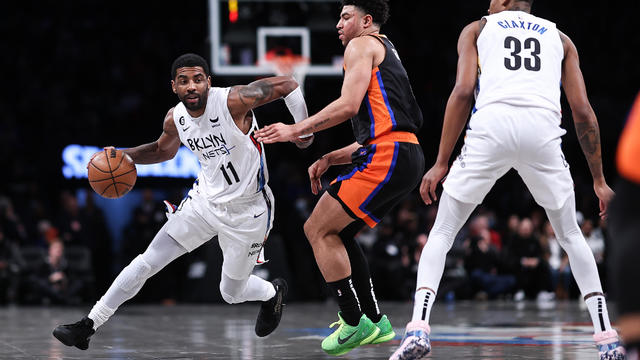 Kyrie Irving #11 of the Brooklyn Nets is guarded by Quentin Grimes #6 of the New York Knicks during the first quarter of the game at Barclays Center on January 28, 2023 in New York City. 