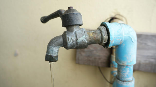 Close up of Chrome faucet and water pipeline 