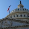 USA Capitol Building dome with American flag flying. 