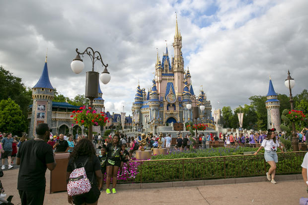 People visit Walt Disney World  in Lake Buena Vista, Florida, 