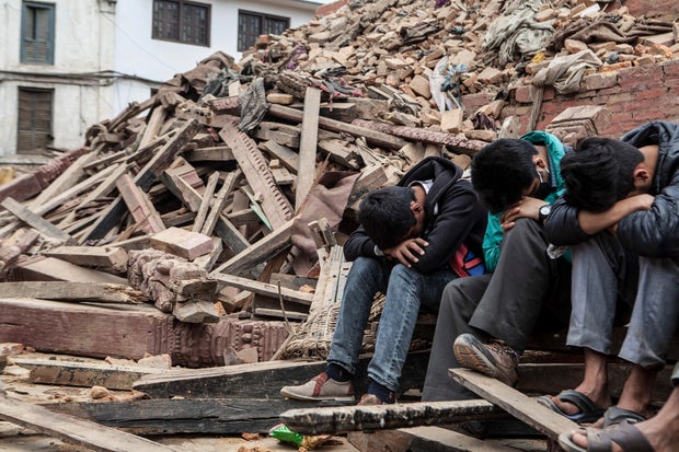 KATHMANDU, NEPAL- APRIL 26: Boys resting in daylight the day af 