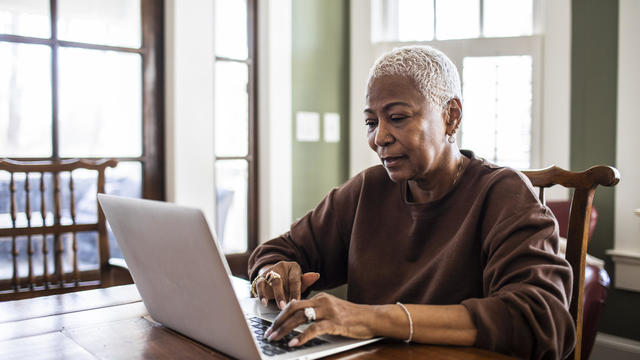 Senior woman using laptop at home 
