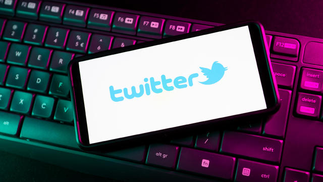 In this photo illustration a Twitter logo seen displayed on 