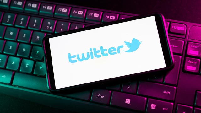 In this photo illustration a Twitter logo seen displayed on 