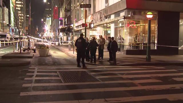 An ambulance and an NYPD vehicle can be seen near Times Square. 