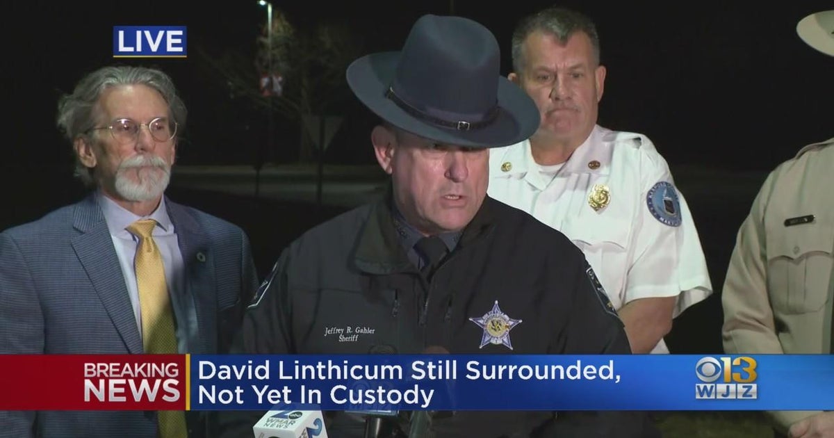 Detective shot as manhunt for suspect in state of crisis continues in