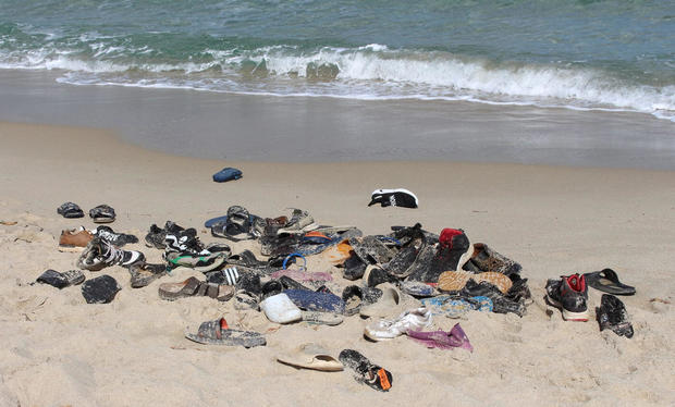 Shoes of immigrants are pictured on the beach, who died after their boat capsized, in Qassr Alkhyar 