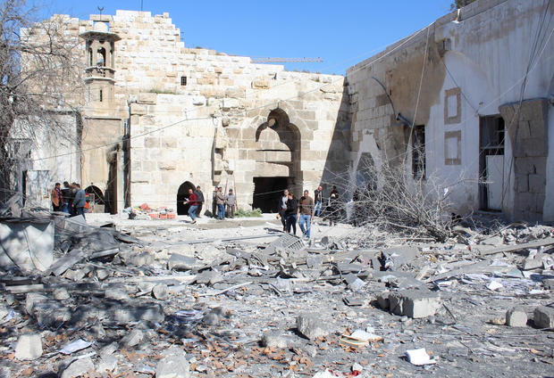 People inspect the damage at the Citadel of Damascus in the aftermath of what state media said were Israeli air strikes in Syria on Feb. 19, 2023. 