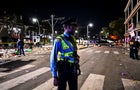 Police officers work at the scene of a shooting that occurred during the Krewe of Bacchus parade in New Orleans, February 19, 2023. 