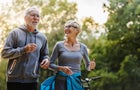 Smiling senior couple jogging in the park 