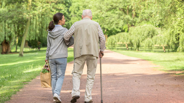Caregiver – woman helping senior man with shopping 