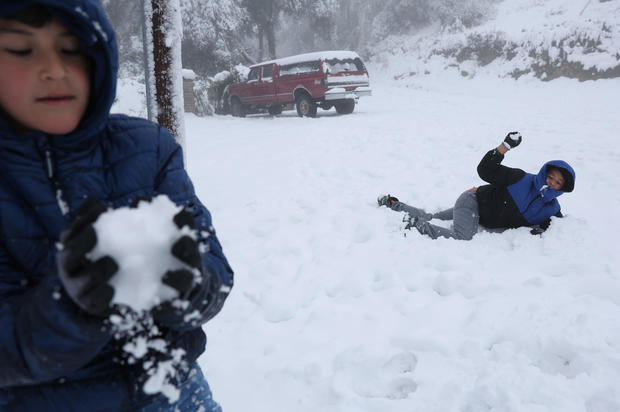 Boys have a snowball fight in Angwin, California 