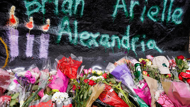 Lansing, MI-February 15, 2023: Students place flowers at the Un 