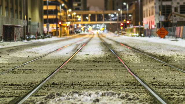 Snowy Train Tracks in City of Minneapolis at Night 