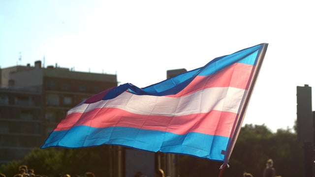 People attend a ceremony at Queens Park for Trans day of remembrance.
