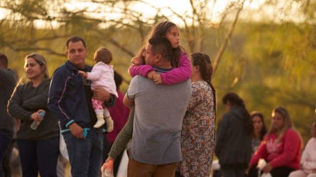 A father holds his daughter after they illegally crossed the U.S. southern border with Mexico on Oct. 10, 2022, in Eagle Pass, Texas. 