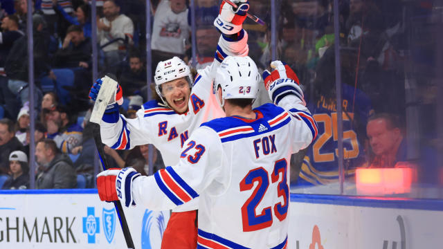 Artemi Panarin #10 of the New York Rangers celebrates his game-winning overtime goal against the Buffalo Sabres with Adam Fox #23 during an NHL game on March 11, 2023 at KeyBank Center in Buffalo, New York. New York won, 2-1. 