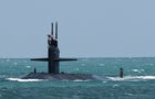 A nuclear-powered U.S. Navy submarine cruises into the Navy 