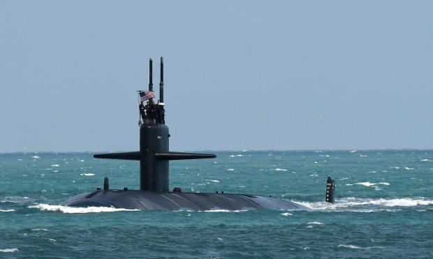 A nuclear-powered U.S. Navy submarine cruises into the Navy 