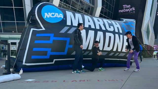 Fans in front of the march Madness inflatable 