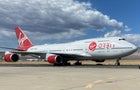 Red and white plane on a runway 