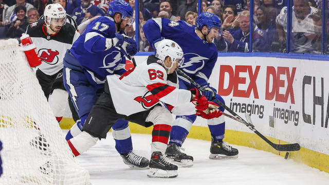 Alex Killorn #17 and Tanner Jeannot #84 of the Tampa Bay Lightning against Jesper Bratt #63 of the New Jersey Devils during the first period at Amalie Arena on March 19, 2023 in Tampa, Florida. 