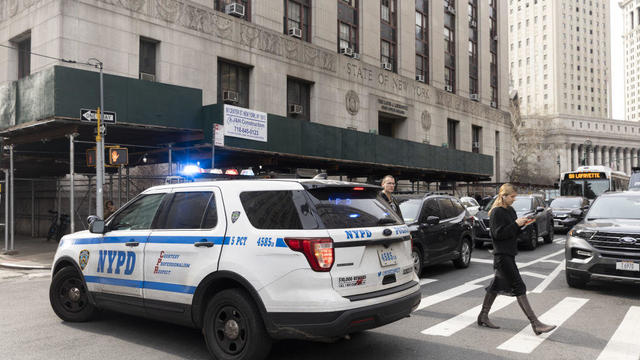 New York police officers gather near the Manhattan criminal court and Manhattan District Attorney's office in New York City on March 22, 2023. 