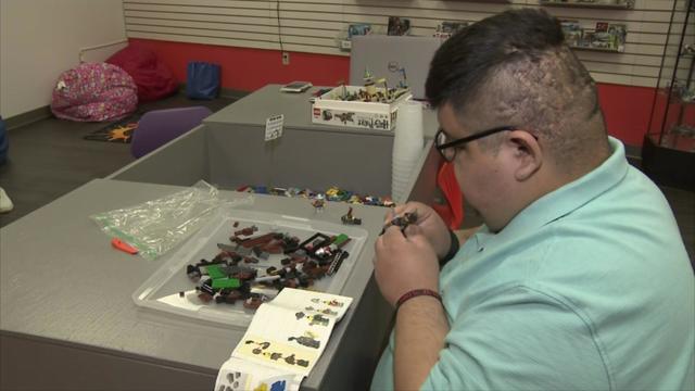 Brandon Buccellato works on a Lego set. 