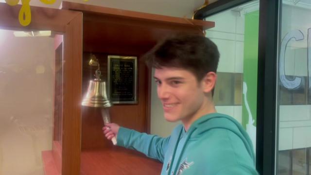 Brandt Morgan rings a bell in a medical center. 