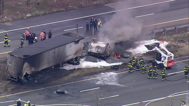 An aerial view of wreckage from a multi-vehicle crash between a tractor trailer, a dump truck and a pickup truck. 