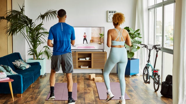 Couple Watching Online Exercise Class At Home
