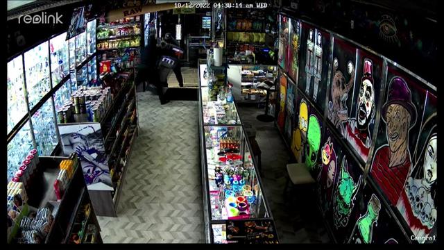Surveillance footage from inside a store shows two men stealing an ATM. 