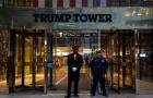 A police officer and a building employee stand in front of Trump Tower in New York on March 30, 2023. 