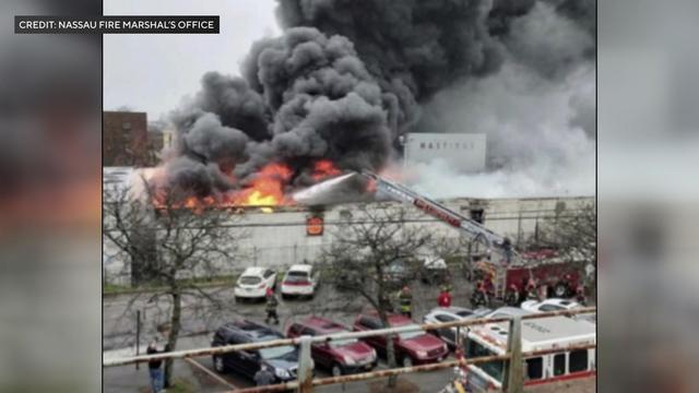 Crews spray water on a massive fire at commercial building. 