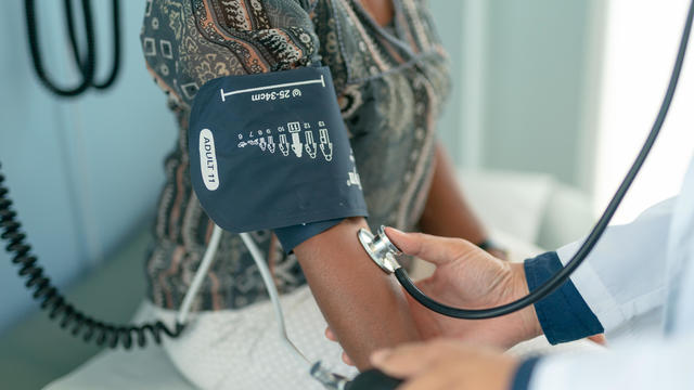 Mature adult woman has blood pressure checked 