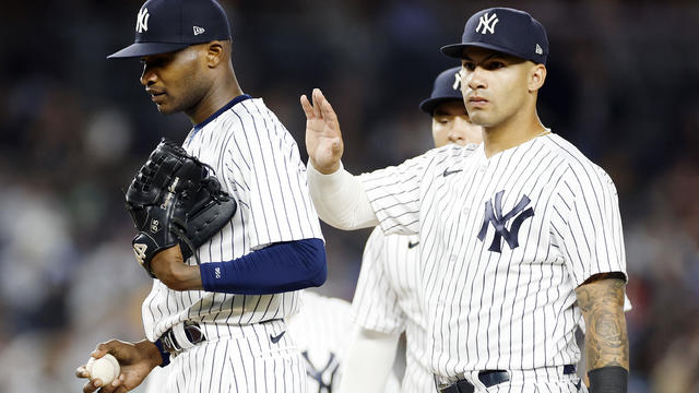 Gleyber Torres #25 pats Domingo German #0 of the New York Yankees on the back as he is taken out of the game during the fifth inning against the Philadelphia Phillies at Yankee Stadium on April 04, 2023 in the Bronx borough of New York City. 