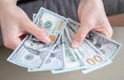 Dollars banknotes in the hands of the housewife. 