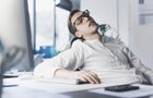 Tired office worker sleeping in the office 